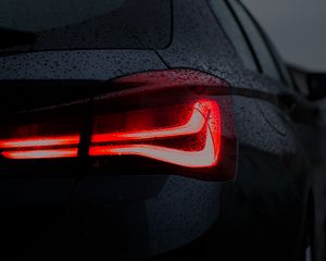 Preview wallpaper car, black, wet, taillight, backlight