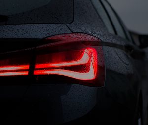 Preview wallpaper car, black, wet, taillight, backlight