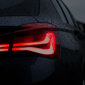 Preview wallpaper car, black, wet, taillight, backlight