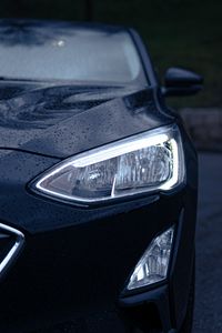 Preview wallpaper car, black, wet, headlights, front view