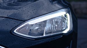 Preview wallpaper car, black, wet, headlights, front view