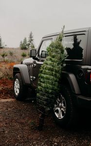 Preview wallpaper car, christmas tree, tree, suv, black