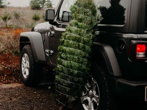 Preview wallpaper car, christmas tree, tree, suv, black
