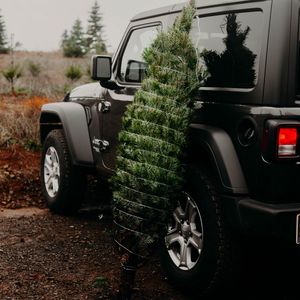 Preview wallpaper car, christmas tree, tree, suv, black