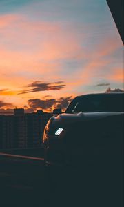 Preview wallpaper car, dark, city, headlight, light, front view