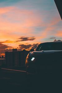 Preview wallpaper car, dark, city, headlight, light, front view