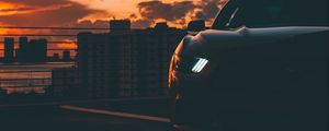 Preview wallpaper car, dark, city, headlight, light, front view