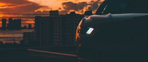 Preview wallpaper car, dark, city, headlight, light, front view