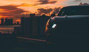 Preview wallpaper car, dark, city, headlight, light, front view