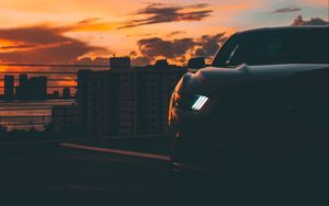 Preview wallpaper car, dark, city, headlight, light, front view