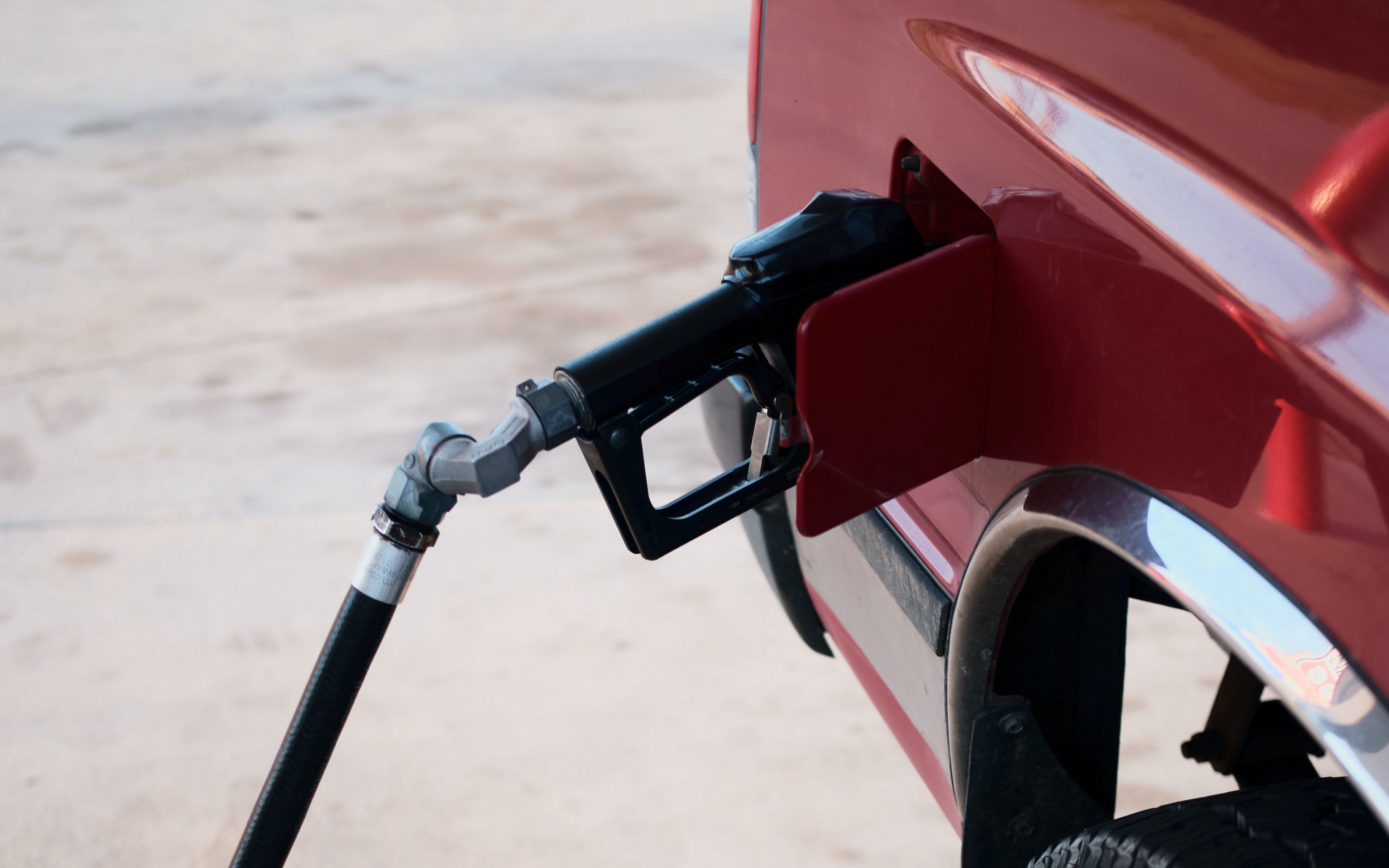 Download wallpaper 3840x2400 car, gas station, wheel, red 4k ultra hd