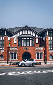 Preview wallpaper car, gray, building, road, asphalt