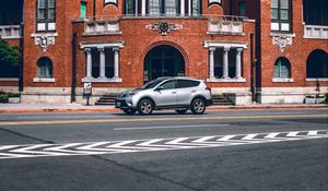 Preview wallpaper car, gray, building, road, asphalt