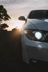 Preview wallpaper car, gray, headlight, sunlight, glare