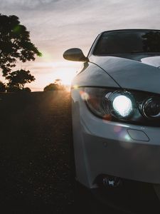 Preview wallpaper car, gray, headlight, sunlight, glare