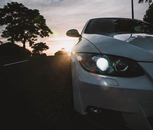 Preview wallpaper car, gray, headlight, sunlight, glare