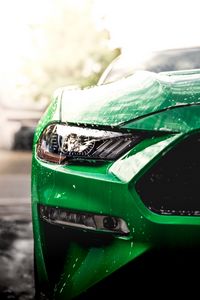 Preview wallpaper car, green, wet, headlight, front view