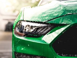 Preview wallpaper car, green, wet, headlight, front view