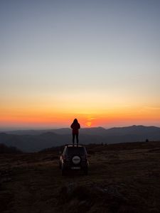 Preview wallpaper car, person, sunset, mountains, nature