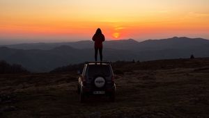 Preview wallpaper car, person, sunset, mountains, nature