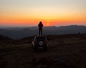 Preview wallpaper car, person, sunset, mountains, nature