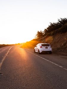 Preview wallpaper car, rear view, road, rays, sun