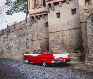 Preview wallpaper car, red, retro, buildings, road