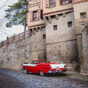 Preview wallpaper car, red, retro, buildings, road