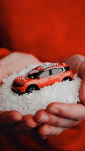 Preview wallpaper car, red, snow, toy, hands