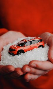 Preview wallpaper car, red, snow, toy, hands