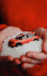 Preview wallpaper car, red, snow, toy, hands