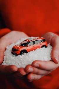 Preview wallpaper car, red, snow, toy, hands