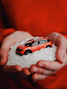 Preview wallpaper car, red, snow, toy, hands