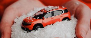 Preview wallpaper car, red, snow, toy, hands