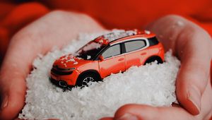 Preview wallpaper car, red, snow, toy, hands