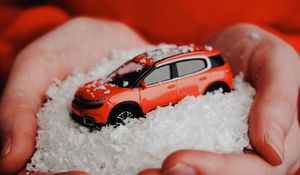 Preview wallpaper car, red, snow, toy, hands