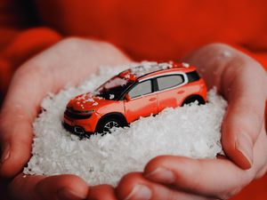 Preview wallpaper car, red, snow, toy, hands