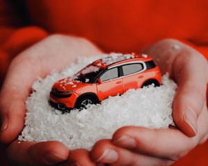 Preview wallpaper car, red, snow, toy, hands