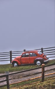 Preview wallpaper car, retro, red, hillock, fence