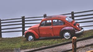 Preview wallpaper car, retro, red, hillock, fence