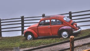 Preview wallpaper car, retro, red, hillock, fence