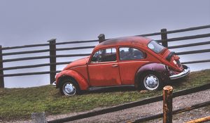 Preview wallpaper car, retro, red, hillock, fence