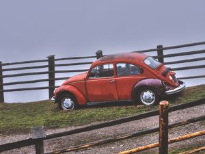 Preview wallpaper car, retro, red, hillock, fence