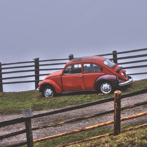 Preview wallpaper car, retro, red, hillock, fence