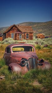 Preview wallpaper car, retro, rust, grass, house, village