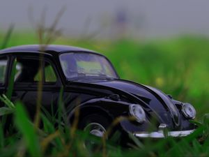 Preview wallpaper car, retro, typewriter, toy, grass