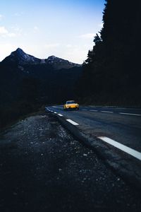 Preview wallpaper car, road, mountains, rocks, marking