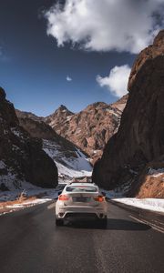 Preview wallpaper car, road, rocks, rear view