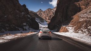 Preview wallpaper car, road, rocks, rear view