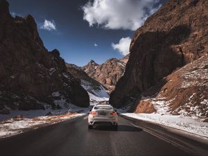 Preview wallpaper car, road, rocks, rear view